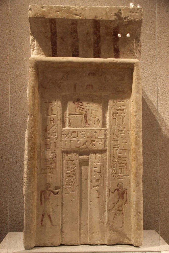 Image 1 clearly shows an Egyptian false door stele with hieroglyphic inscriptions and offering scene, matching the…