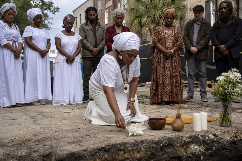 A figure honors the enslaved and free Black residents believed buried beneath 106 Coming Street