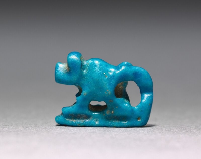 A high-resolution Egyptian faience amulet in characteristic turquoise-blue glaze from the First Intermediate Period,…