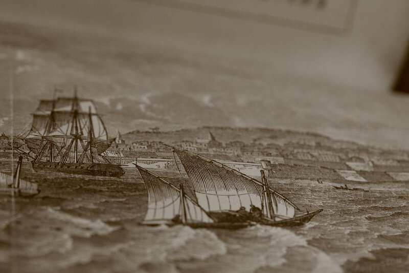 A historical steel engraving of sailing vessels on the coast best matches the maritime shipwreck research context.