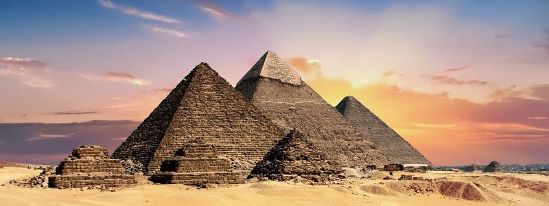The panoramic Giza pyramids at sunset directly illustrates the ancient Egyptian landmark central to the article
