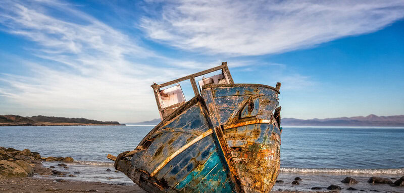 Ancient shipwreck timbers protrude from a Nantucket beach, belonging to a hull that matches no known historical record.