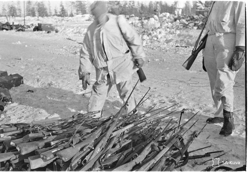 SA-kuva photo shows Finnish soldiers with captured Soviet rifles in winter whites, directly depicting the broader Finnish&hellip;